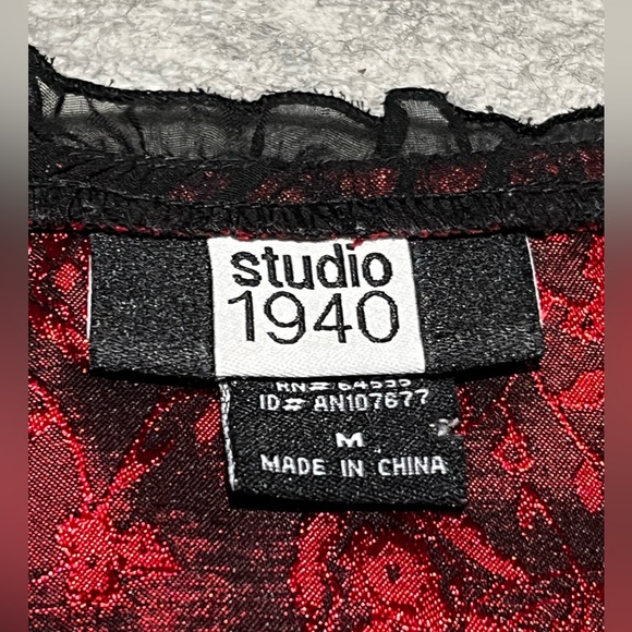 Red and black elegant top with frilly details around the collar and shoulders. - Picture 3 of 4